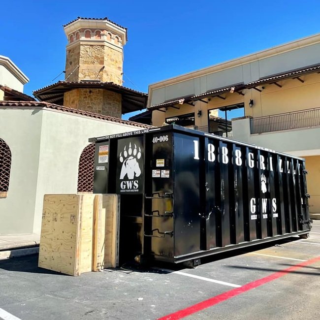grizzly waste solutions dropping off a residential dumpster rental near me in san antonio texas