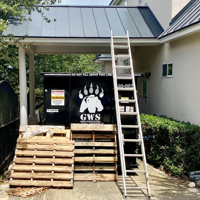 one of our dumpsters at a roofing dumpster rental site in san antonio